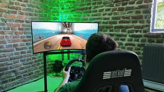 Logitech G29 wheel in front of system running The Crew Motorfest on GeForce Now